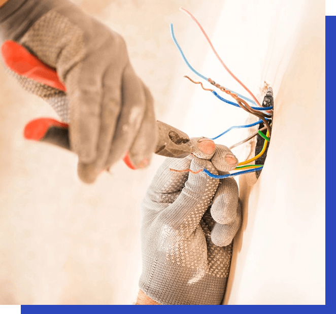 A person is working on the wires of an electrical box.