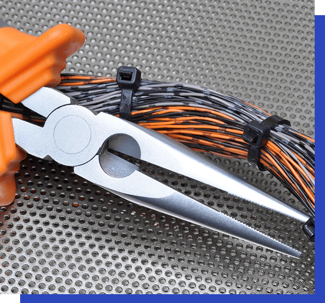 A pair of scissors with orange handles and wires attached to them.